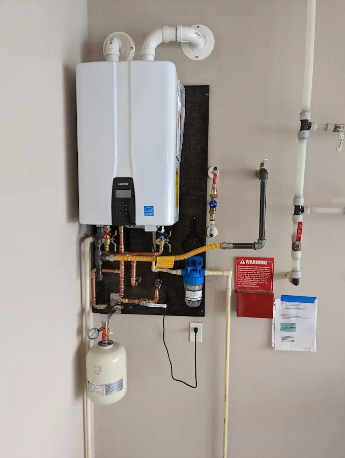 Professional plumber installing copper piping in a Jefferson home